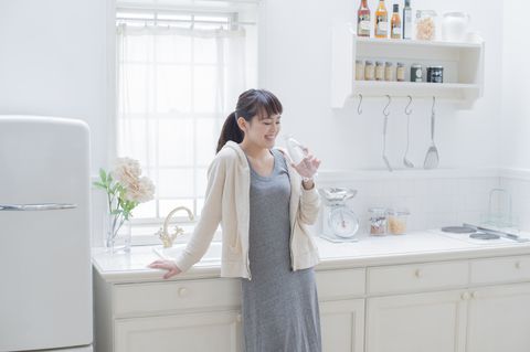 japansk woman drinking a bottle of water.